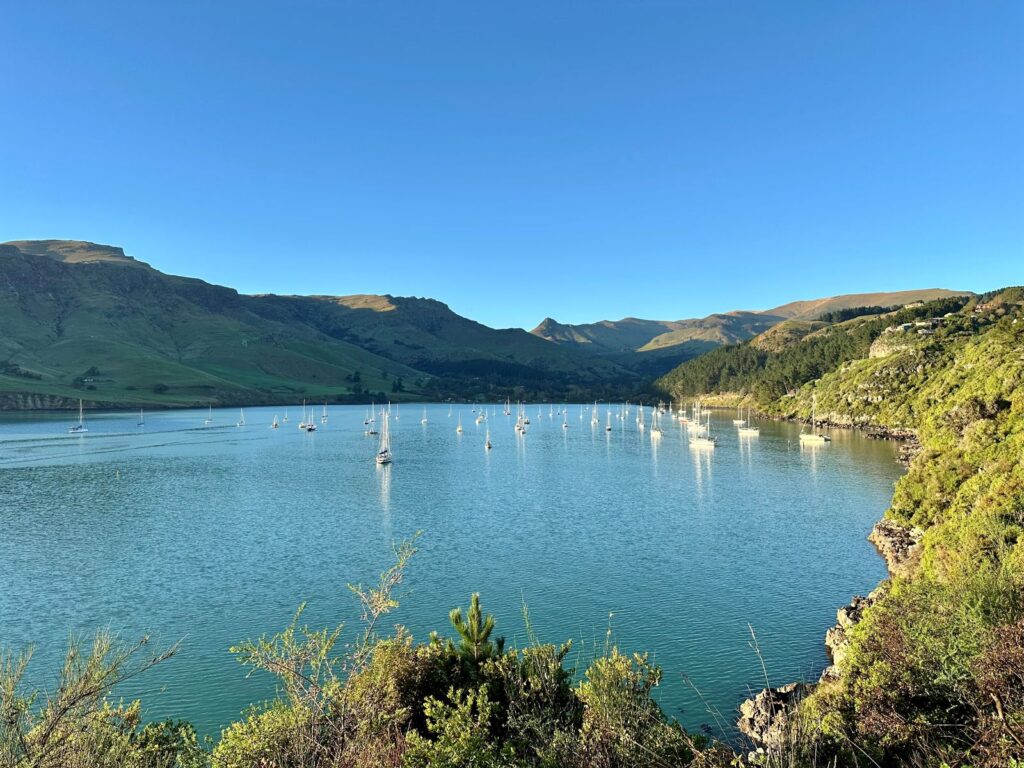 Morning sunrise landscape looking over bright blue water and blue skies