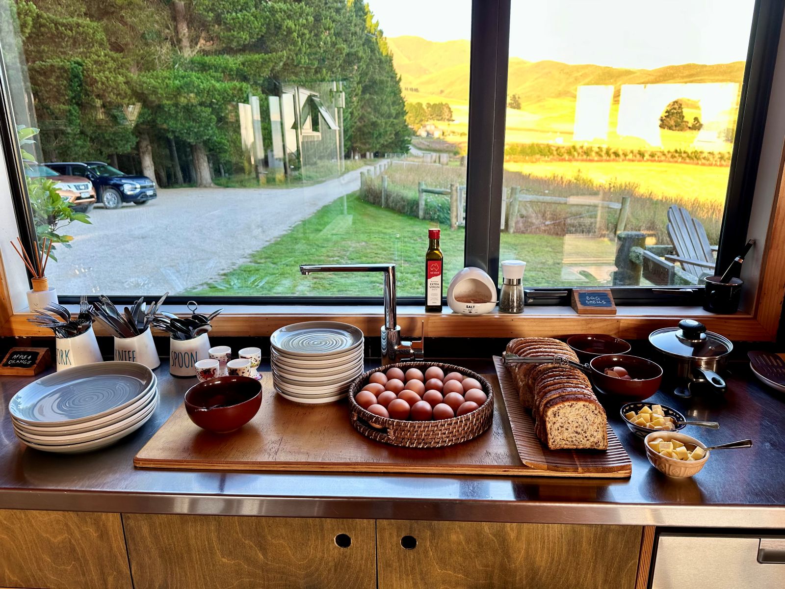 Some healthy breakfast options laid out looking outside of a window during sunrise