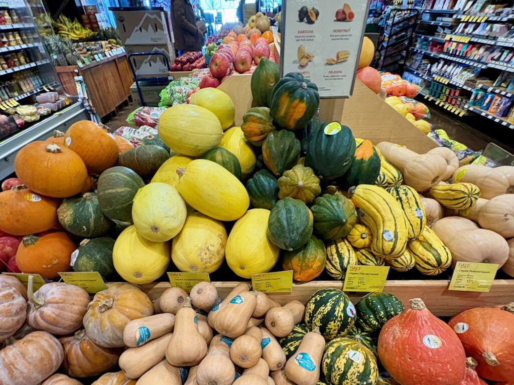 Immune-boosting foods for travel - various colourful vegetables at a grocery store