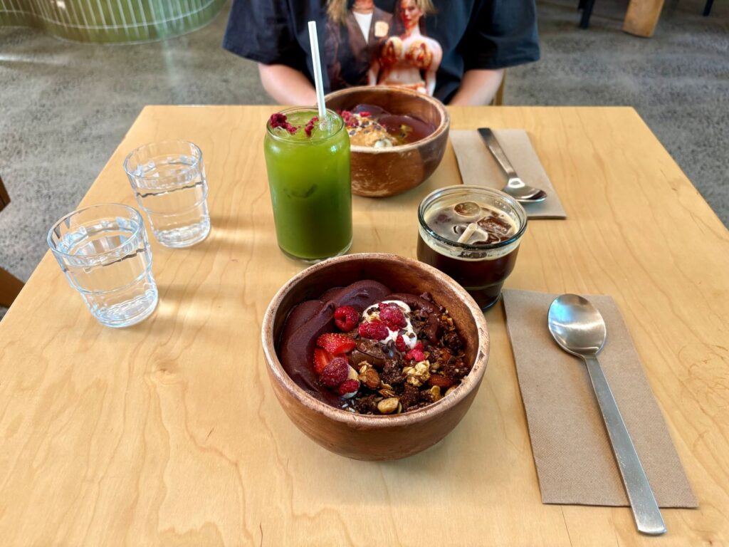 Two acai bowls and an iced matcha coconut water at a health brunch foods cafe