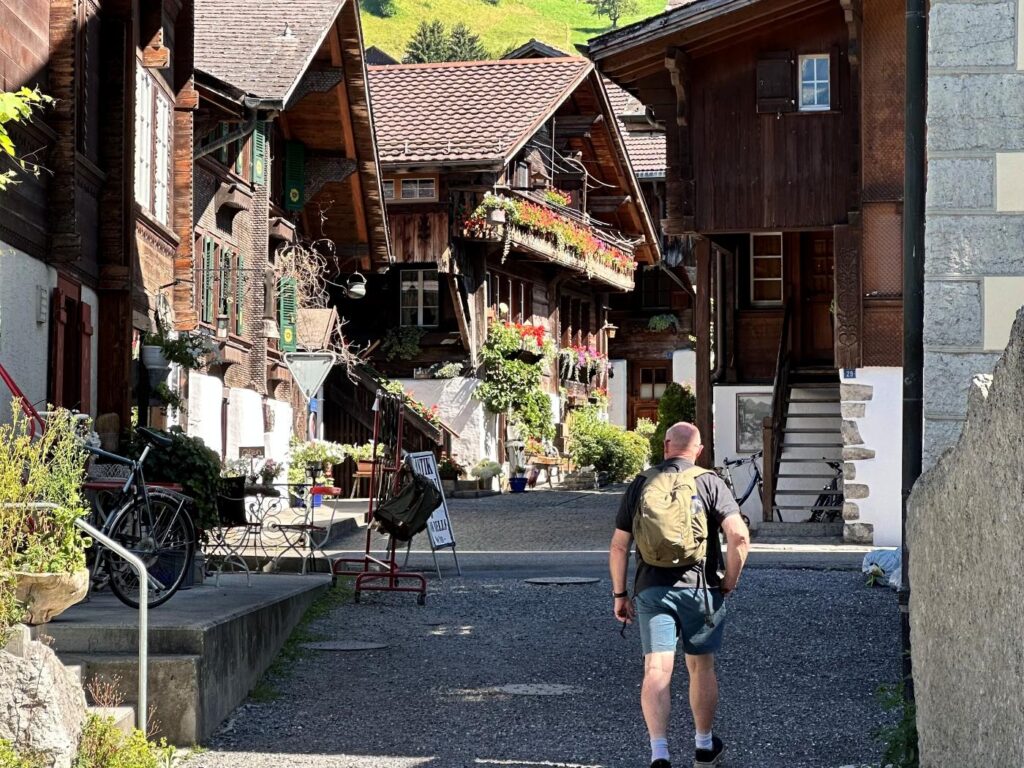 Man walking through street practicing mindful travel as he looks at his surrounds