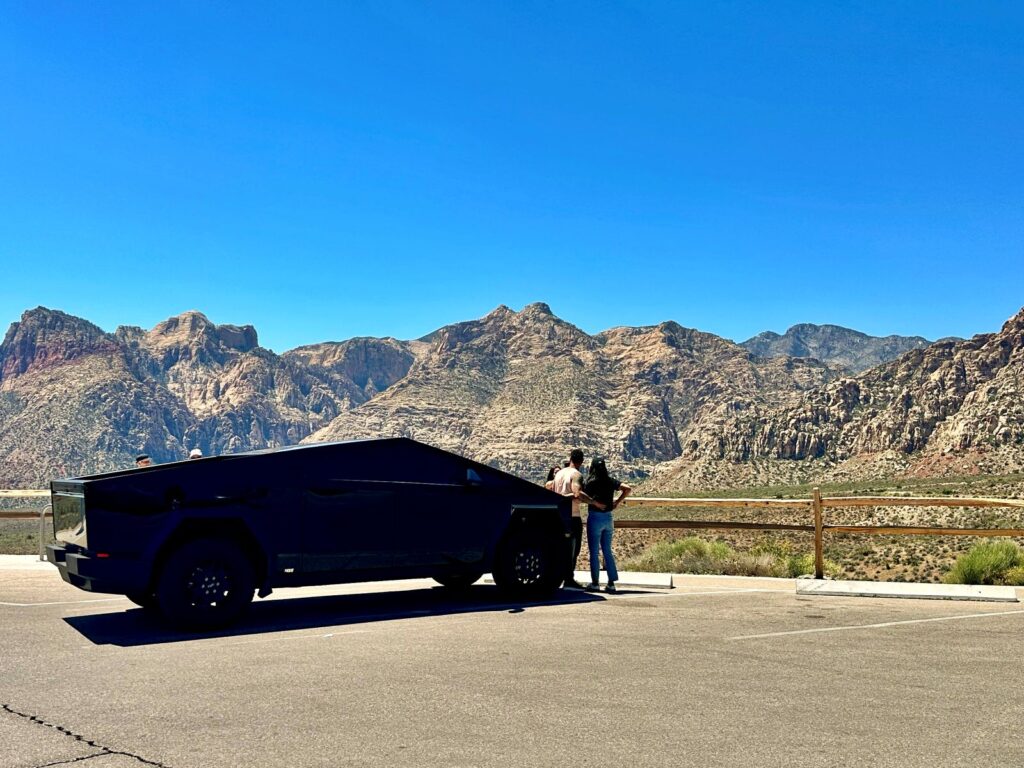 People and car stopped at a viewpoint during the Red Rock Canyon National Conservation Area scenic loop