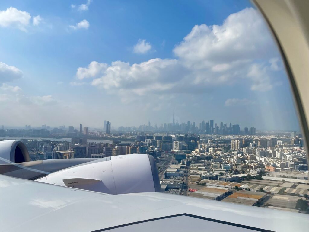 View out of plane window, blue skies with cloud