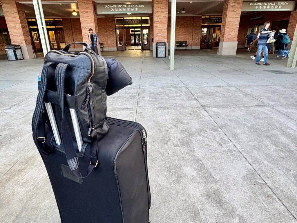 Waiting at a train station with luggage