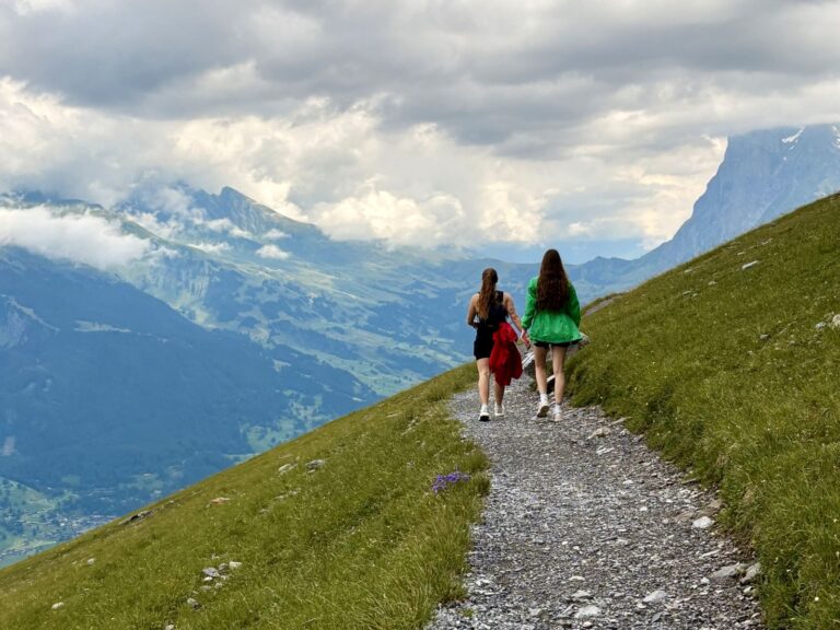 Group travelling together two girls hiking in Switzerland