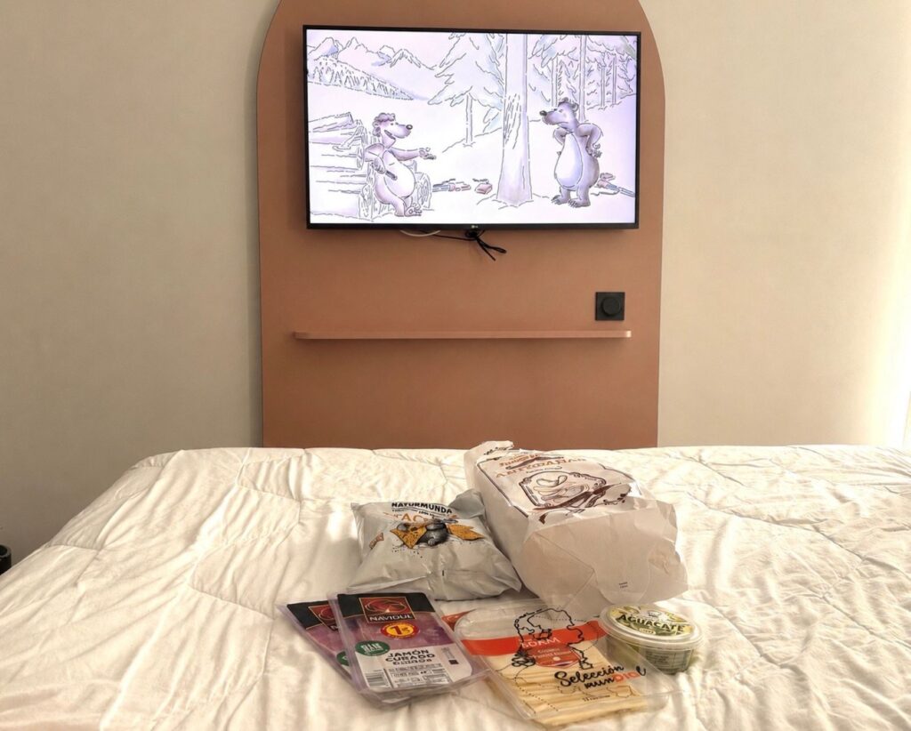 Food from a supermarket sitting on a hotel bed as a way to try to reduce consuming so many ultra-processed foods while travelling