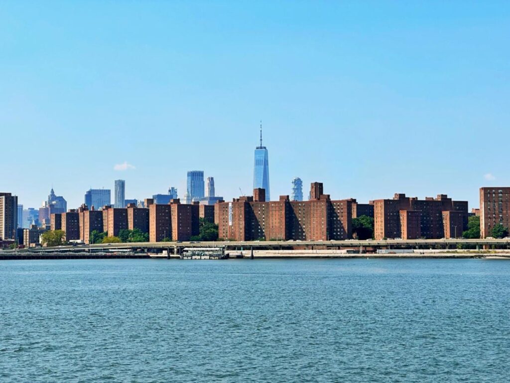 Skyline view of NYC while taking public transport on a NYC ferry on a sunny summer day