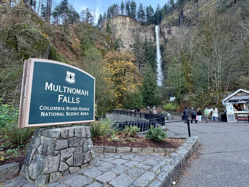 The sign of Multnomah Falls in Oregon with the falls in the background