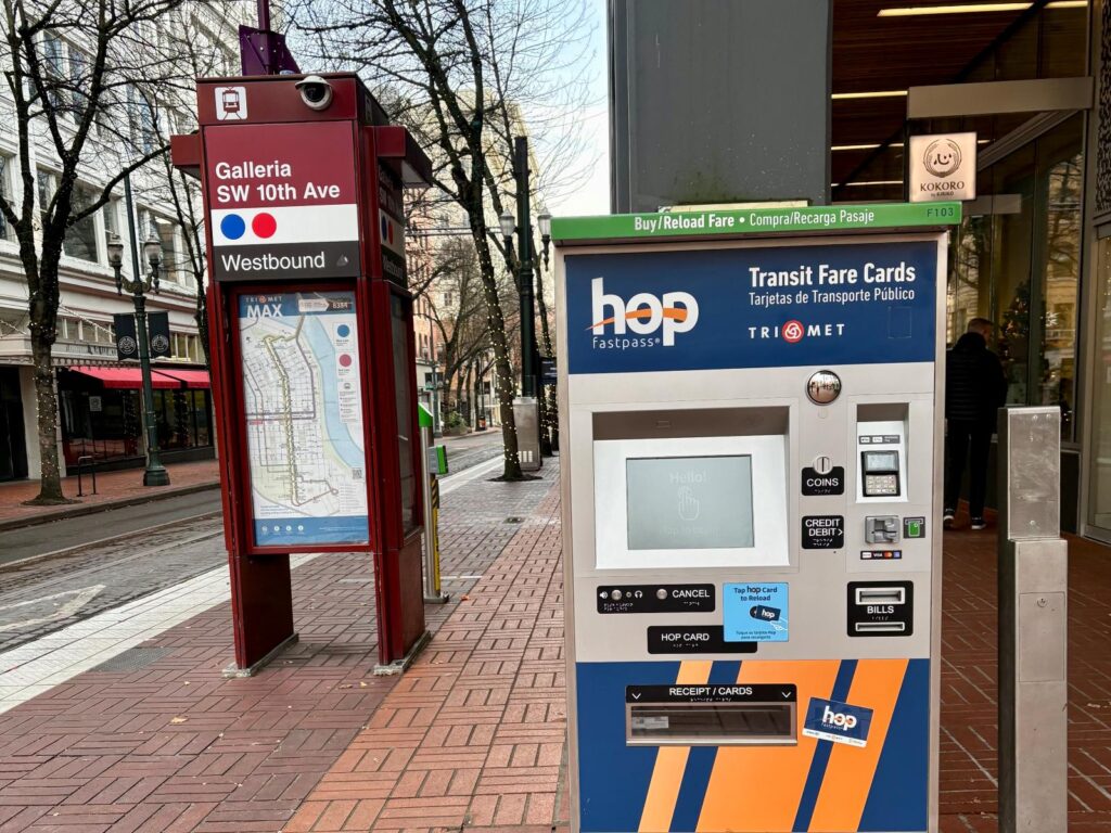 Paying to use public transport in Portland showing a payment stand at a stop to tap on