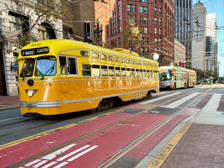 Using public transport in San Francisco - light rail and bus in the distance