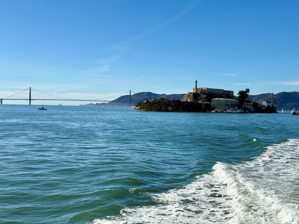 Using public transport in San Francisco, taking boat with a view of Alcatraz and Golden Gate Bridge in background