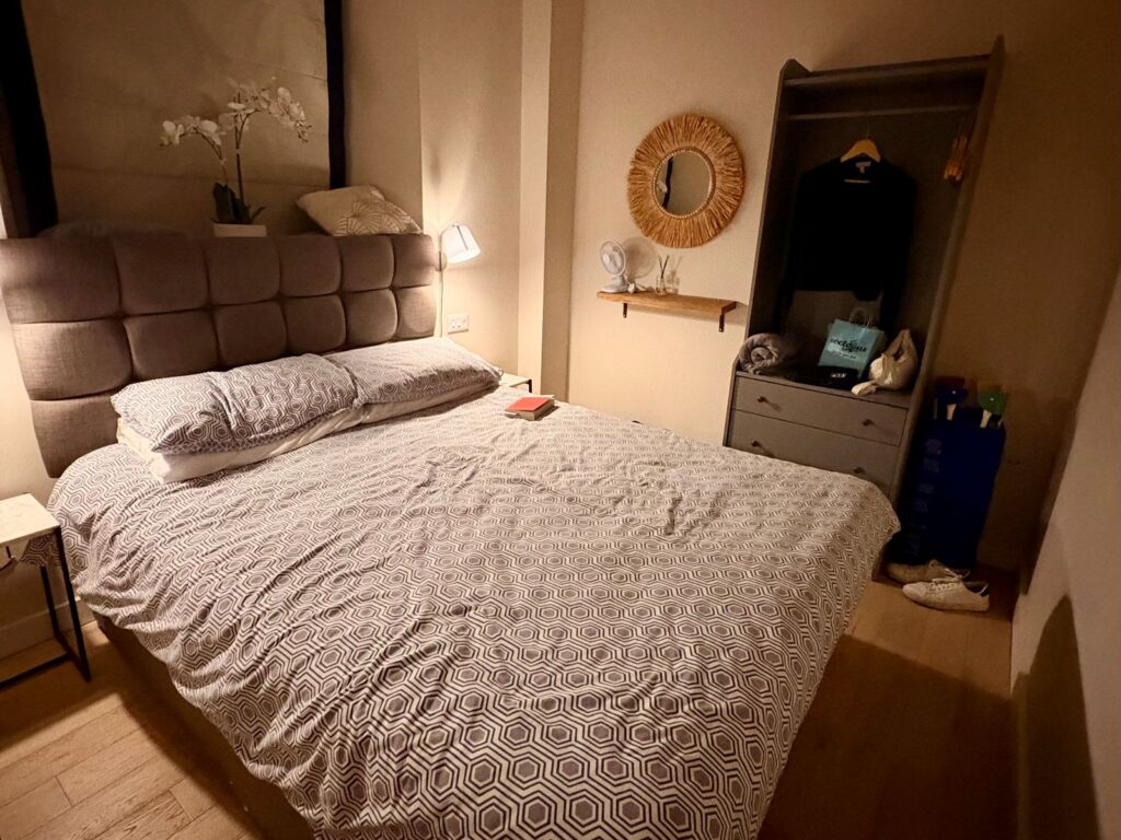 A room lit at night by a dim lamp supporting sleeping well while travelling