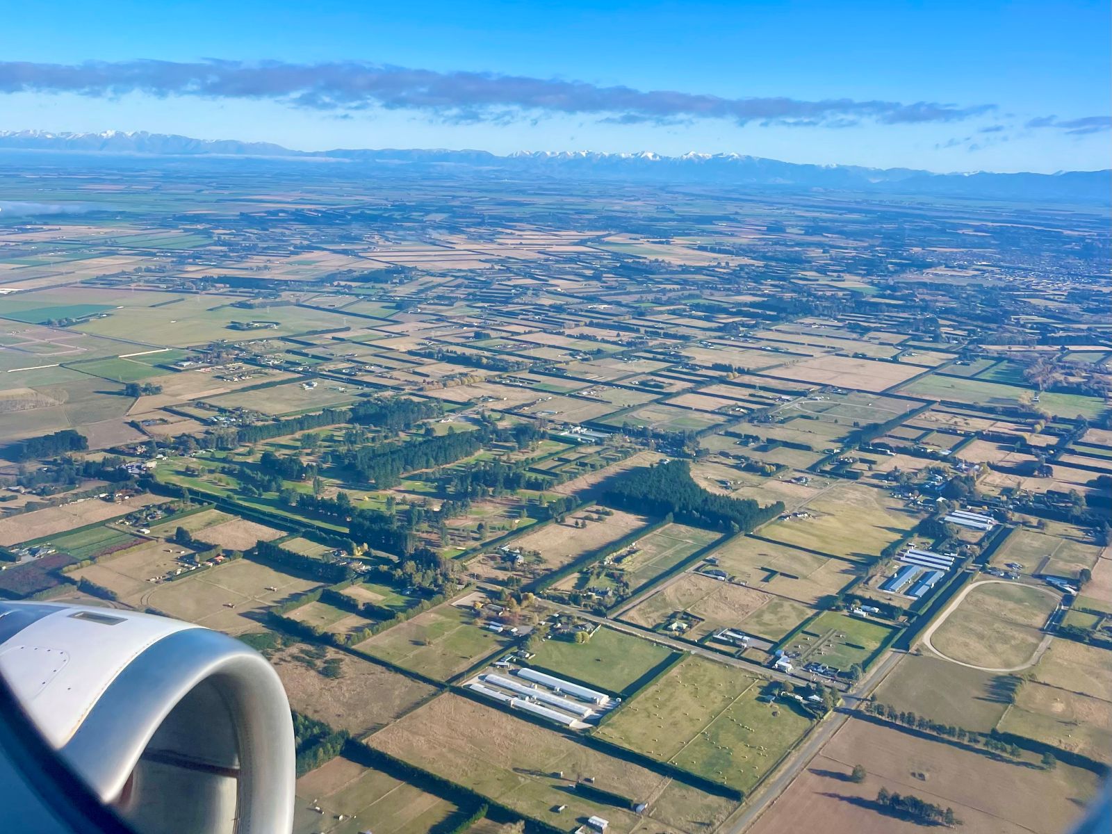 View out of plane window with lots of paddocks in view