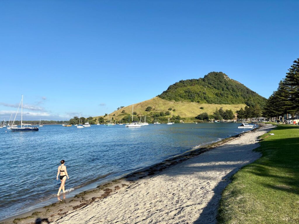 Woman walking with feet in the water on a sunny morning