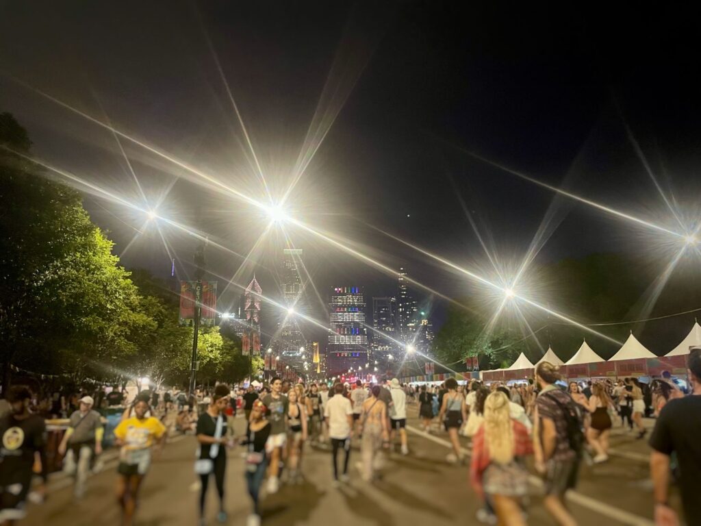 Late night walking out of a festival in a crowd relating to how to sleep at a music festival