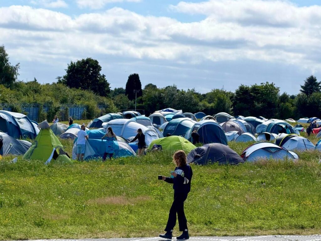 A campsite at a music festival relating to how to sleep at music festivals when camping