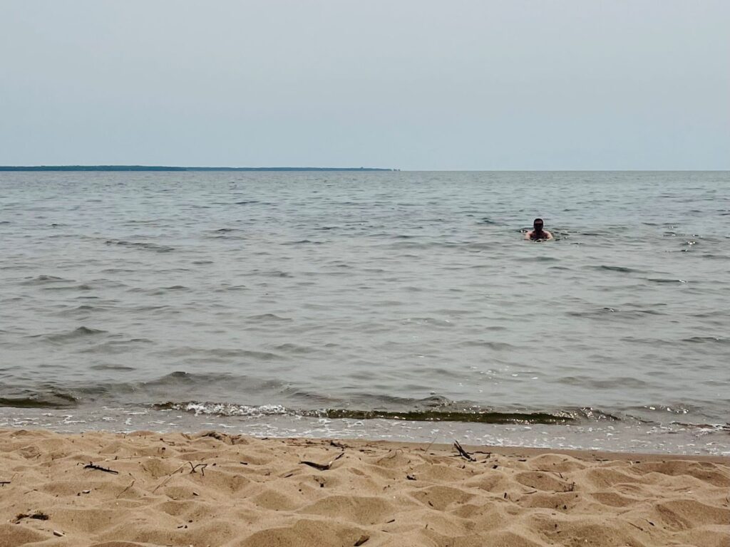 A man swims in Lake Michigan on a Lake Michigan road trip