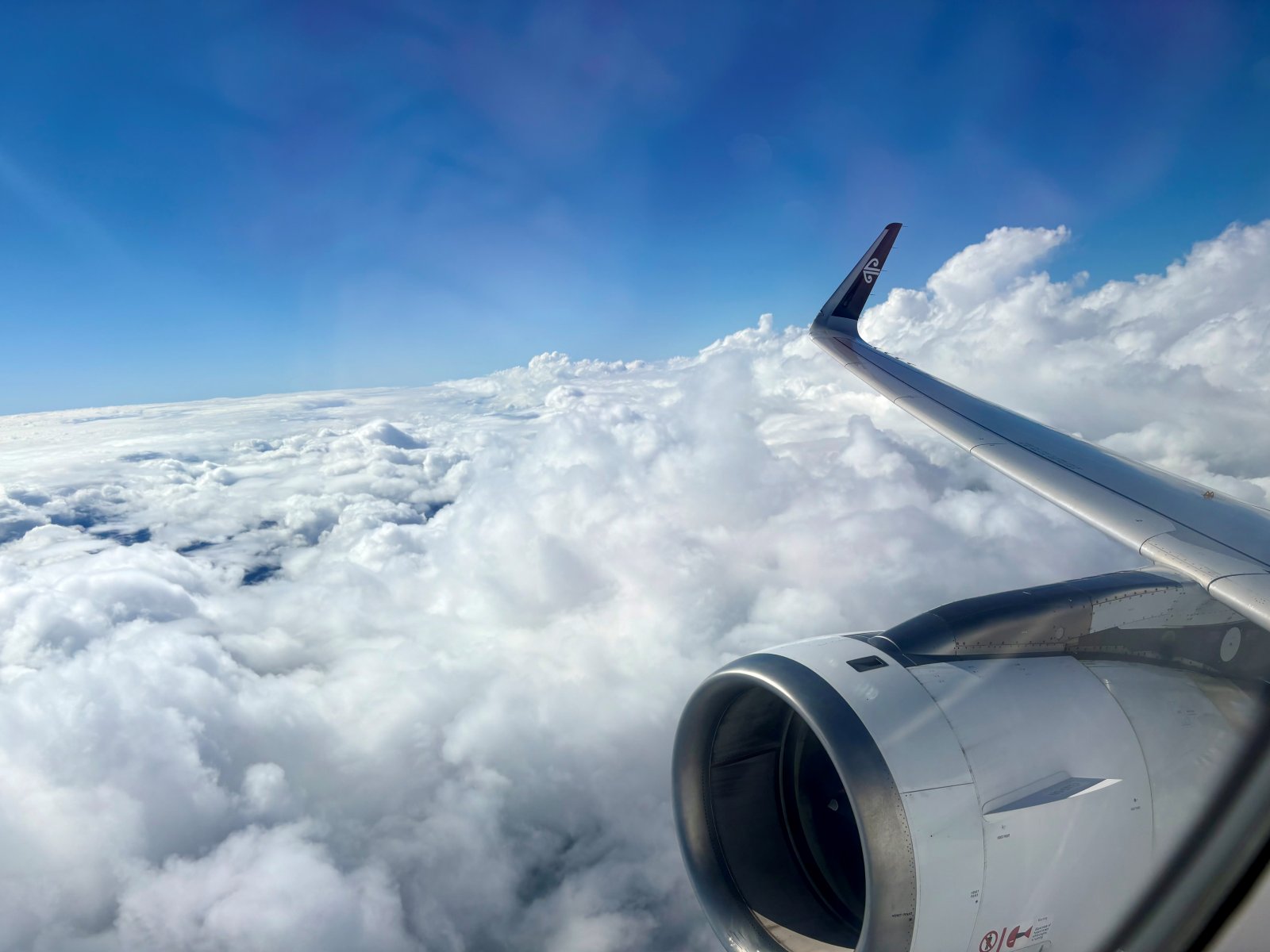 View out of plane window looking at clouds