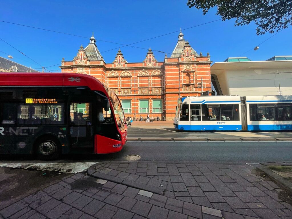 Using public transport in Amsterdam a bus and tram in shot