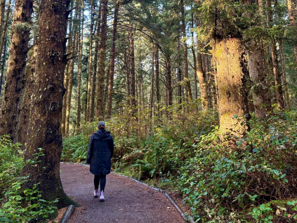 Woman walking through forest trail