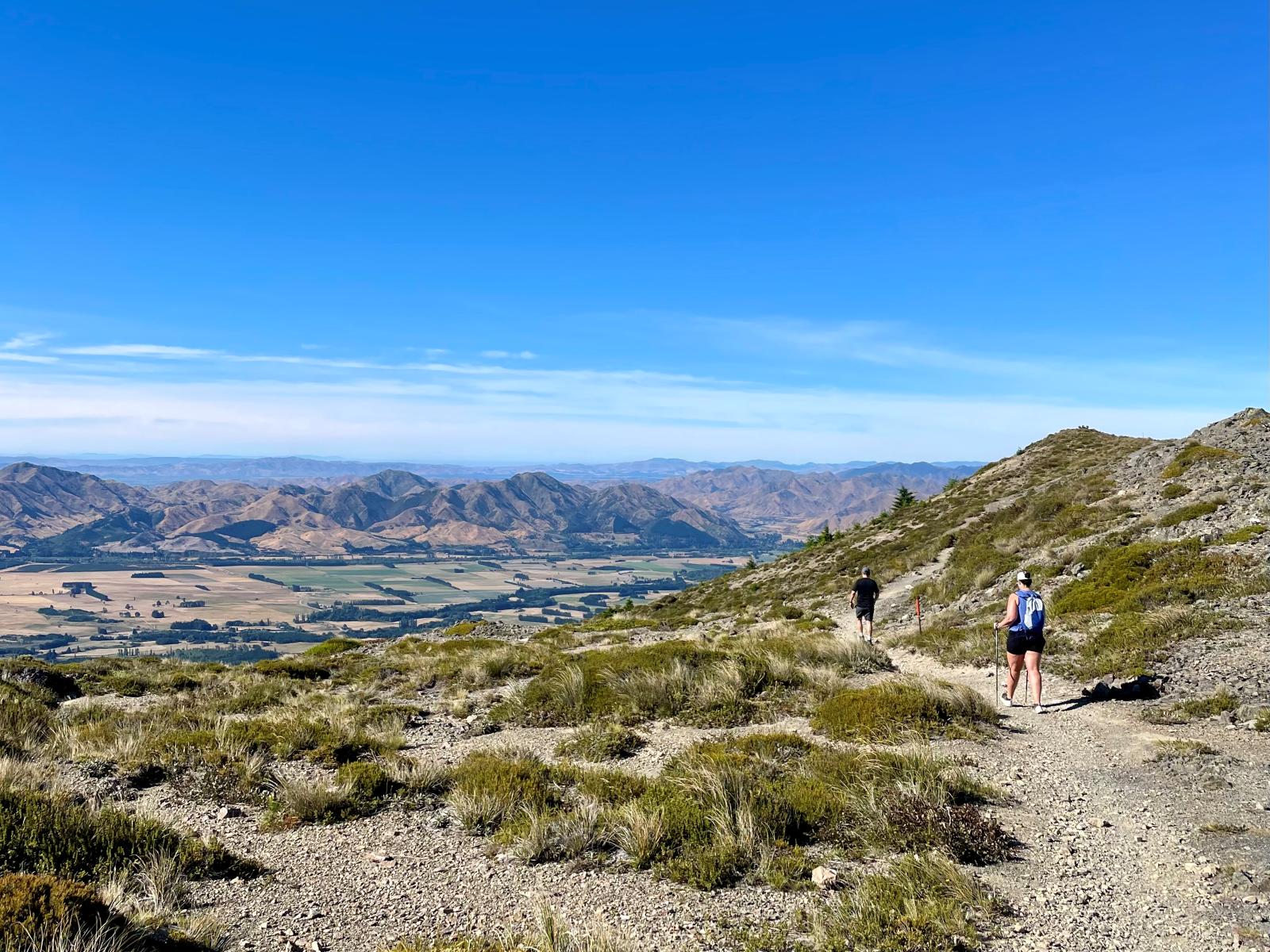 Two people hiking while travelling in Hanmer, New Zealand