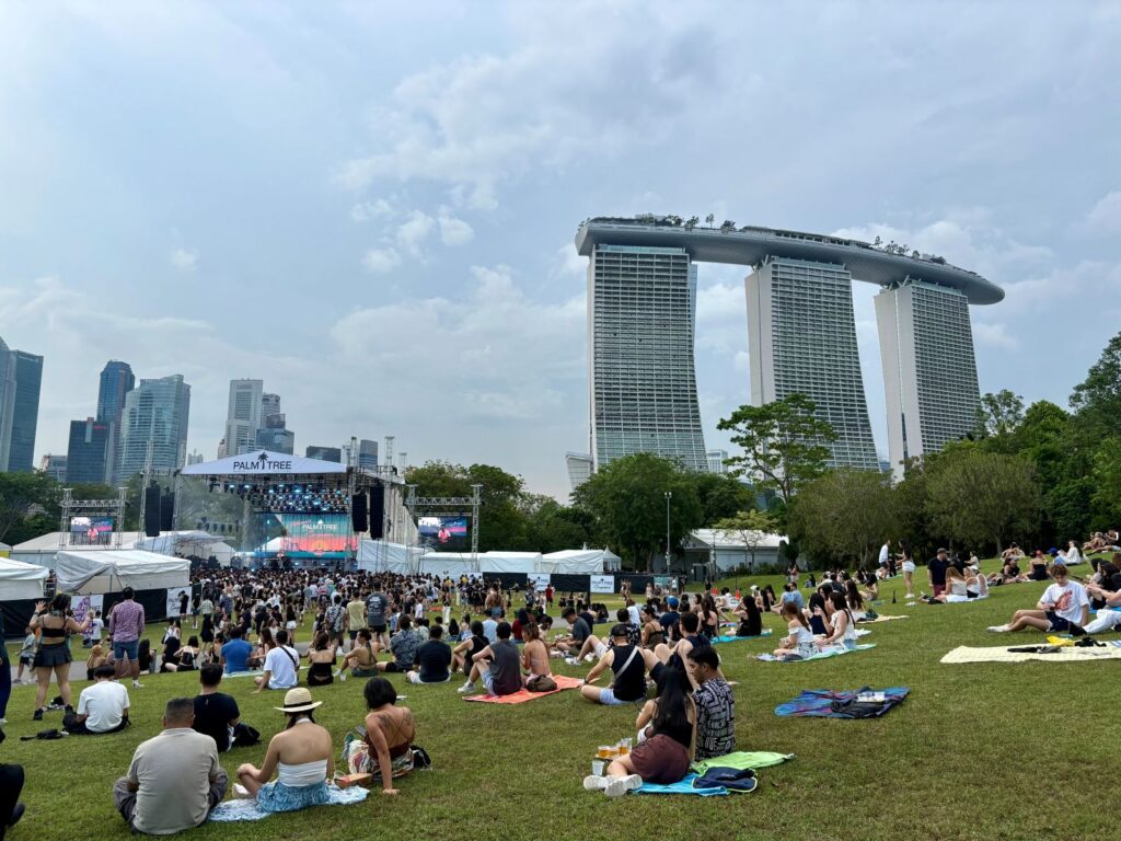 People sitting down at a festival in Singapore, coping with the heat