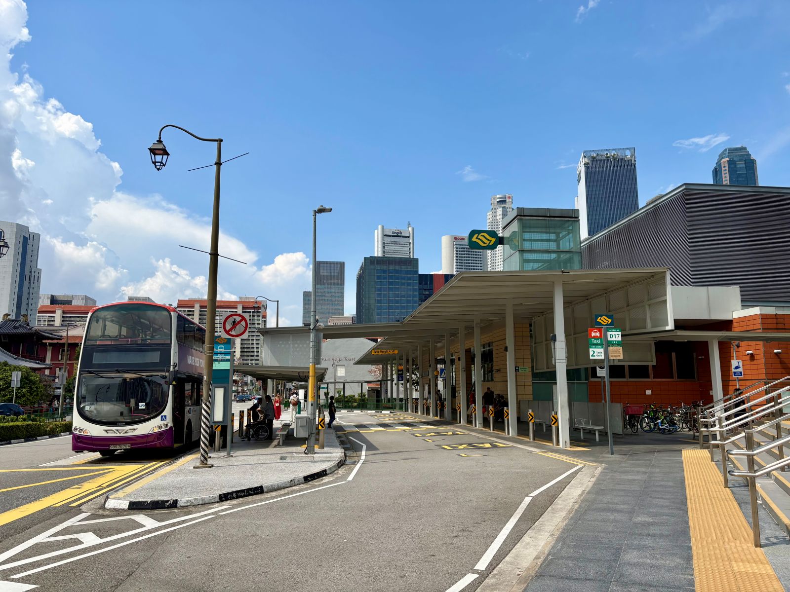 A bus at bus stop next to a MRT station in Singapore