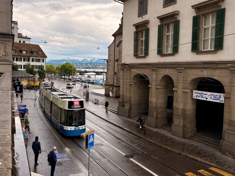 A tram in Zurich, Switzerland with passengers about to alight using public transport in Switzerland
