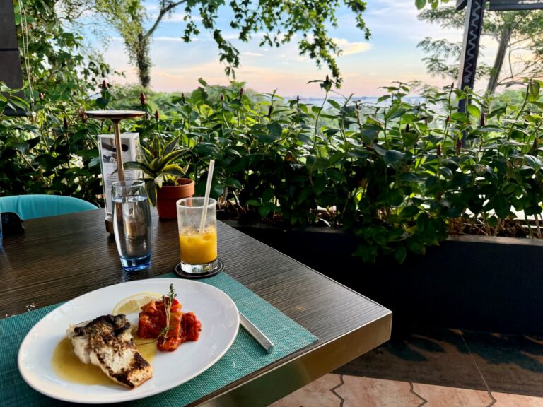 Looking out at sunset in Sentosa eating a gluten-free meal in Singapore