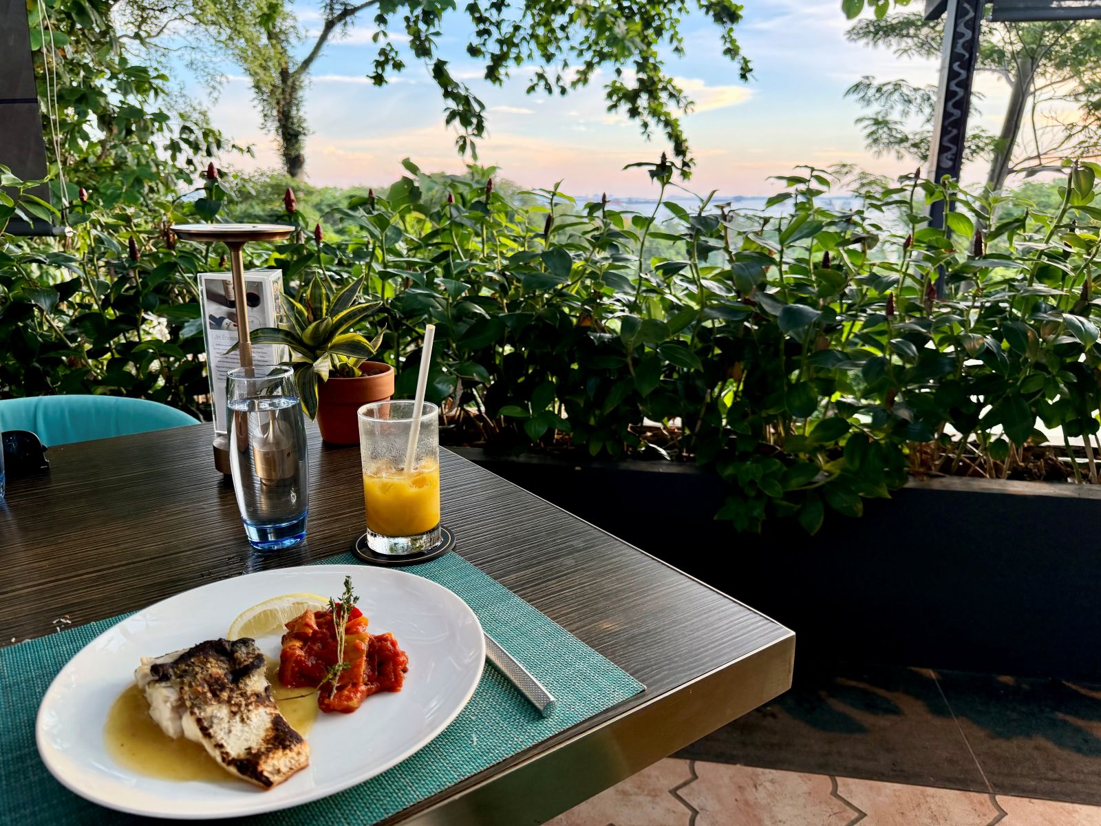 Looking out at sunset in Sentosa eating a gluten-free meal in Singapore