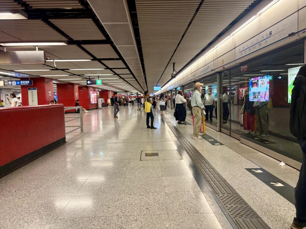 People using public transport in Hong Kong waiting at MTR station