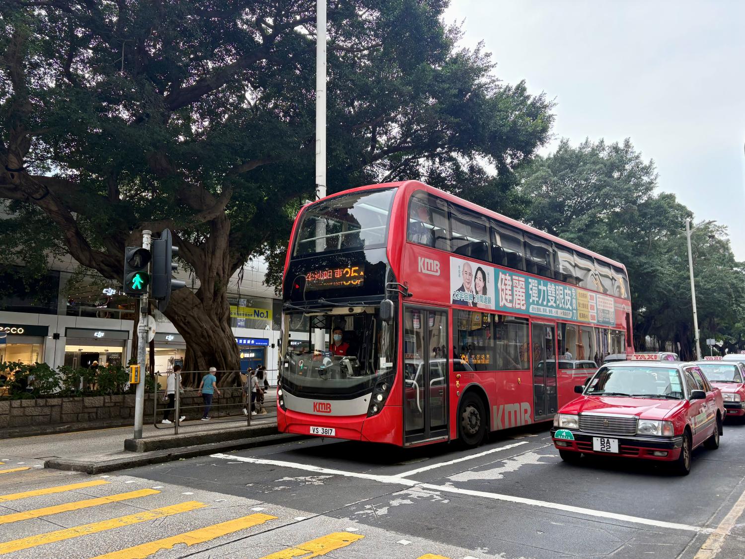 A bus and a taxi on a road in central Hong Kong