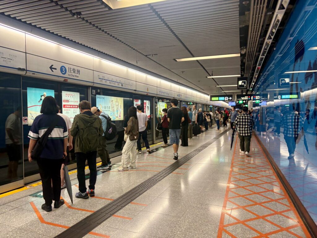 Using the MTR in Hong Kong at an underground station waiting for the train