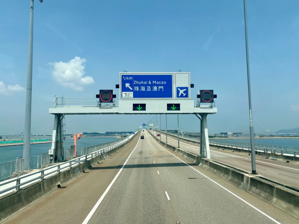 Highway with signage Hong Kong to Macau on board a Golden Bus