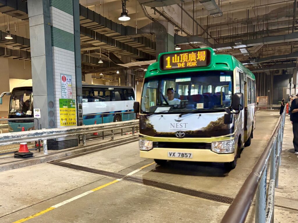 A mini bus in Hong Kong driving up to a stop to collect passengers