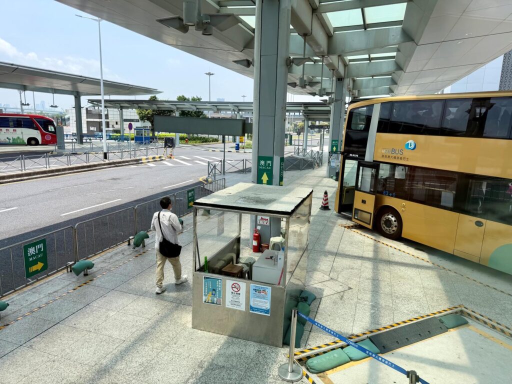 View of a Golden Bus from another Golden Bus, waiting to depart Hong Kong