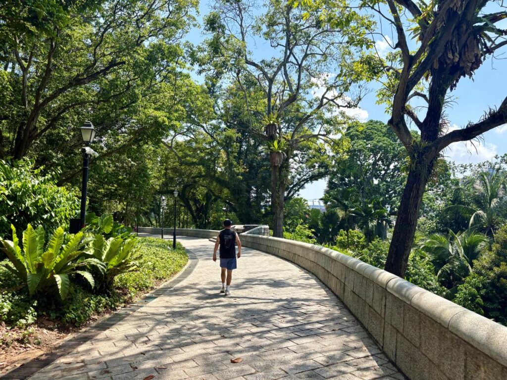 Solo man walks through Fort Canning park showing Singapore good for solo travel