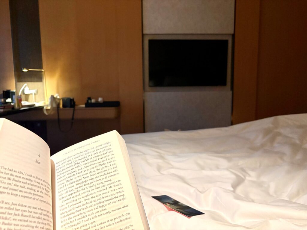 Night time routine reading in a hotel room with dim lights