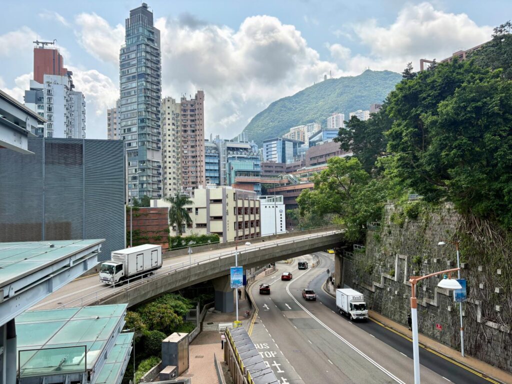 A contrast between the city and nature, crossing over to start a hike in Hong Kong