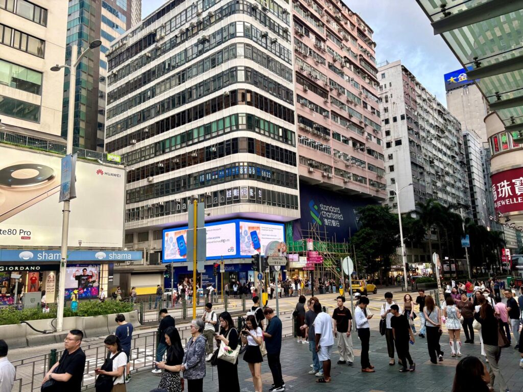 A crowded street showing how different Hong Kong vs Singapore can feel with crowds