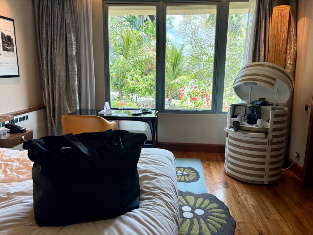 Checking into hotel room with luggage on bed highlighting if sleep tourism is worth it