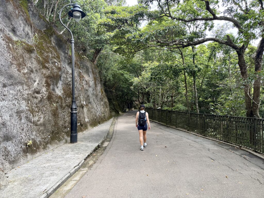 Woman walks along a hiking path in Hong Kong