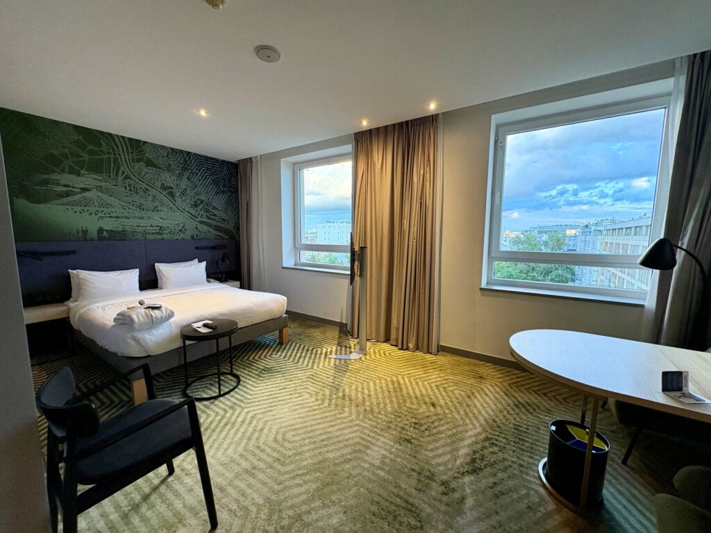 A hotel room upon arrival with nice views outside windows and spacious accommodation