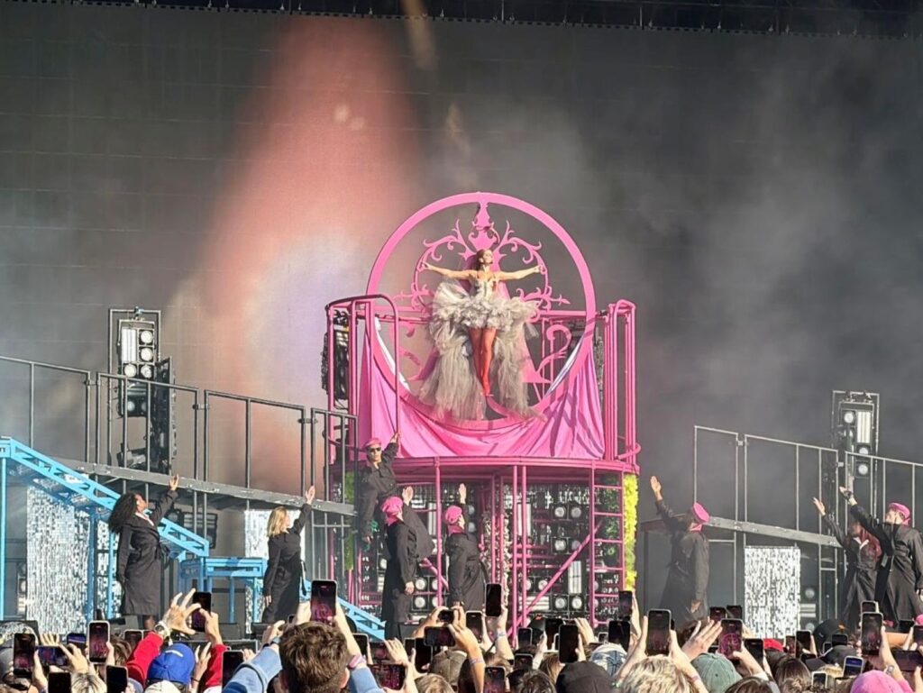 A festival crowd cheering on and videoing Addison Rae on her opening song at Open'er festival, Poland