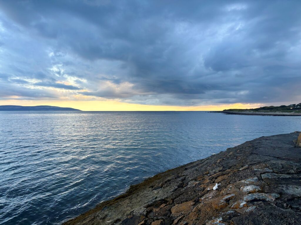 Coastal walk during the evening in Ireland watching the sun set
