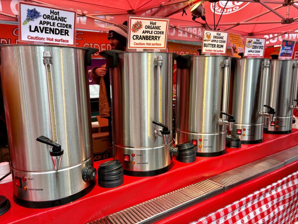 Enjoying the range of seasonal drinks with hot apple cider at Seattle public market
