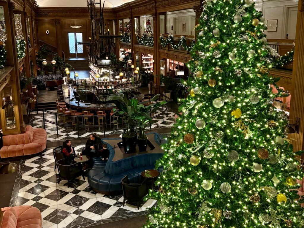 Spending Christmas alone while travelling overseas in a hotel lobby decorated with Christmas trees